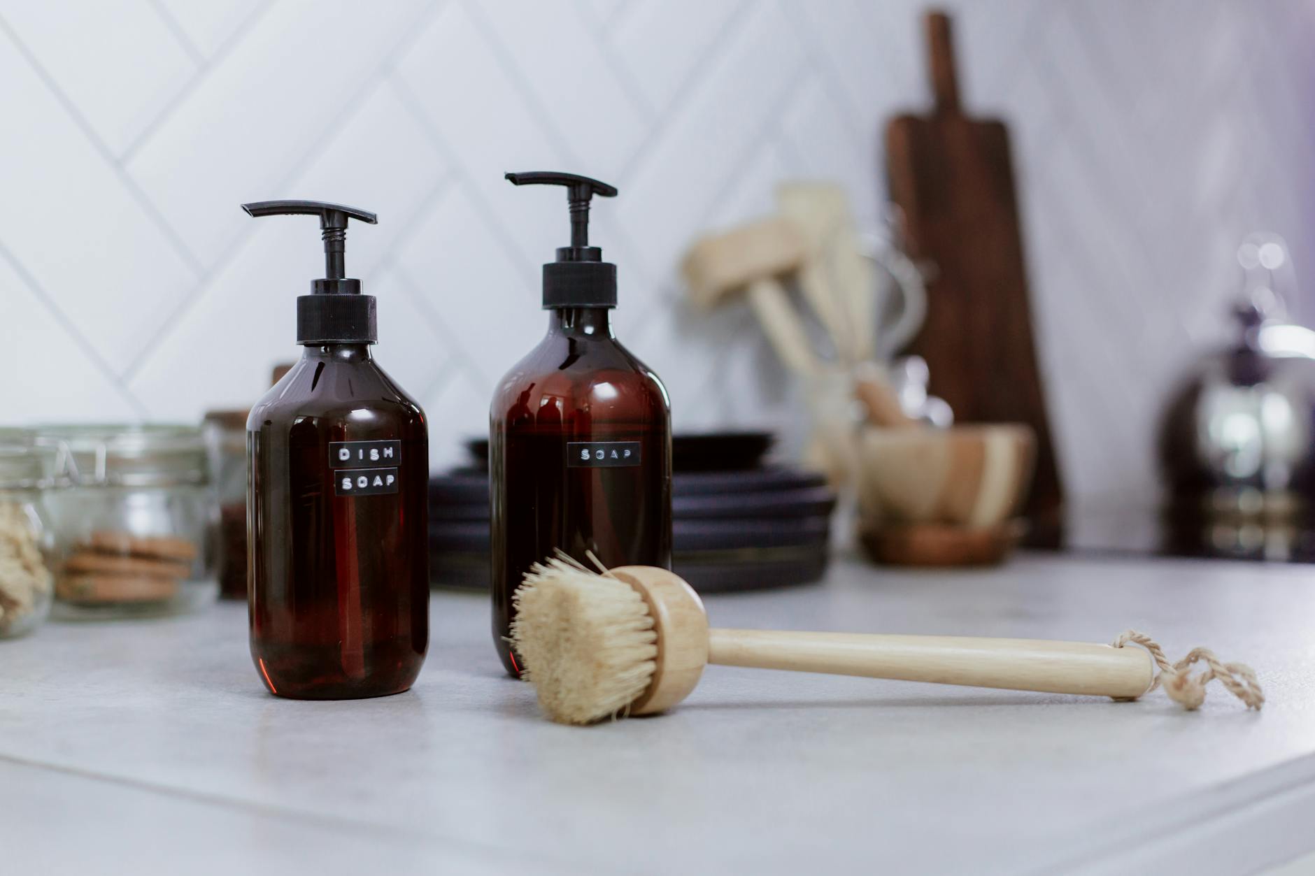 A tidy kitchen countertop with a few everyday items arranged neatly near a sink