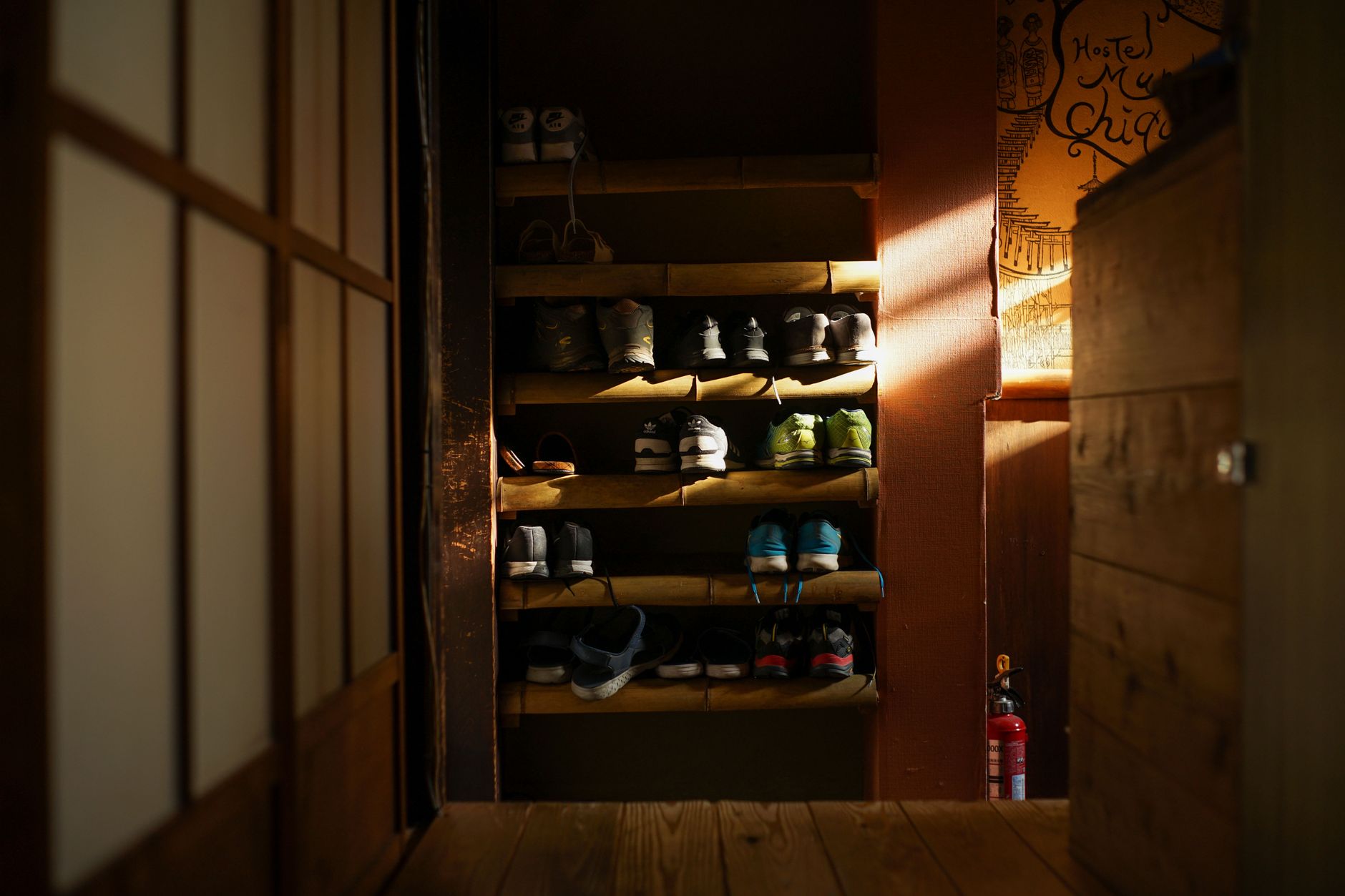 small entryway with shoes, bags, and a simple storage bench