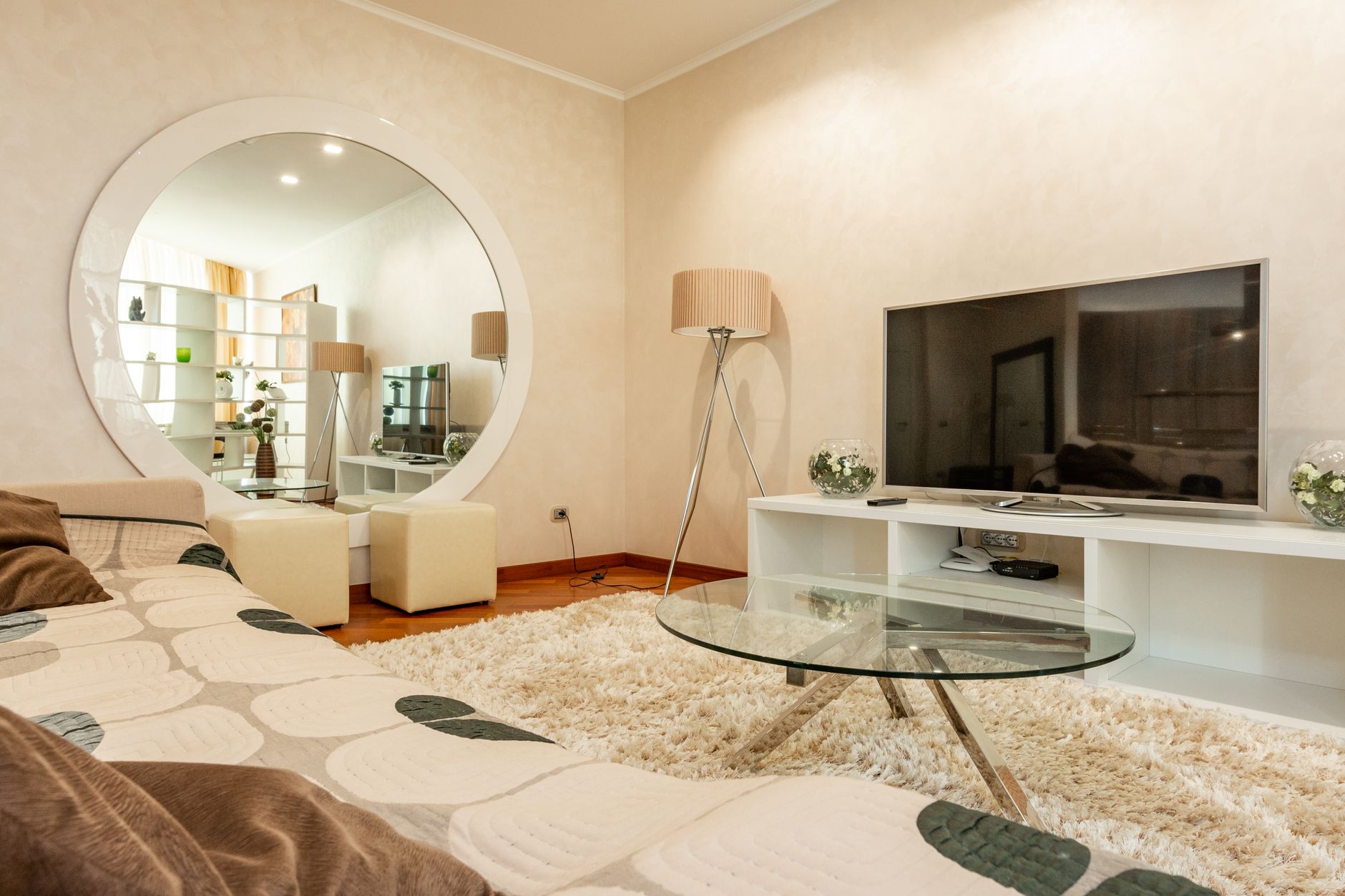 A cozy living room with a large mirror and balanced wall decor