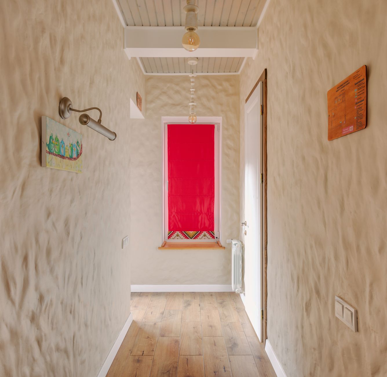 A narrow home space styled to feel warm, intentional, and ready for guests