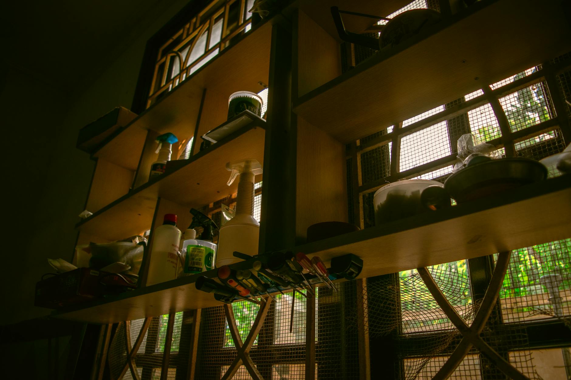 A neatly organized kitchen with open shelves and calm, warm lighting.