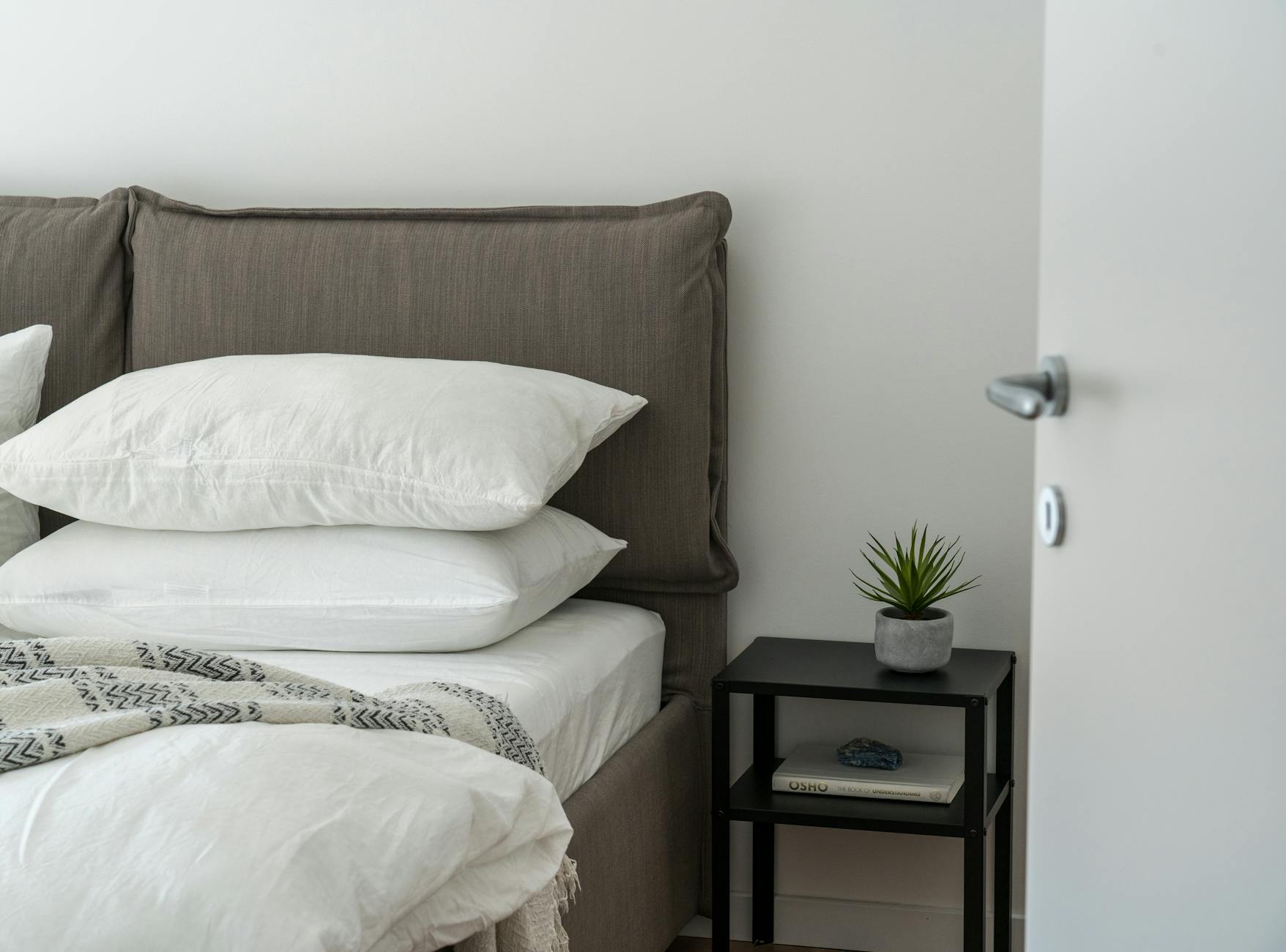A cozy guest-ready room with soft bedding and a tidy side table